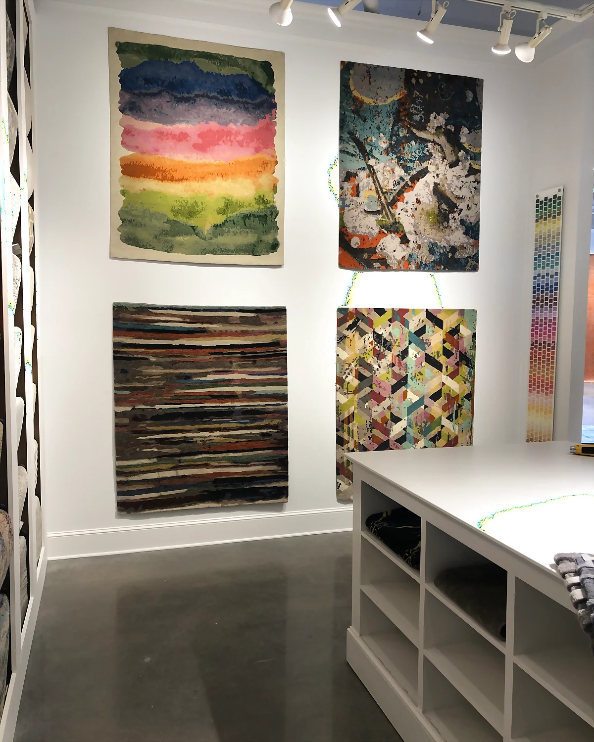 Contemporary rugs displayed on the wall inside Arsin Rug Gallery